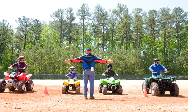 Adults and children on ATVs