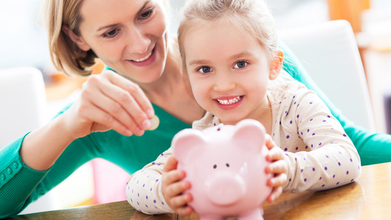 mom and daughter replenish the piggy bank