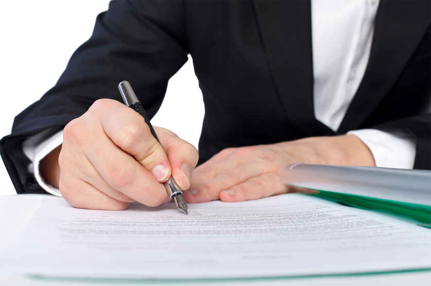 a man draws up documents for a child