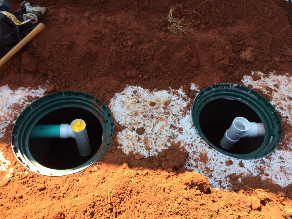 at what distance from the house do septic tanks