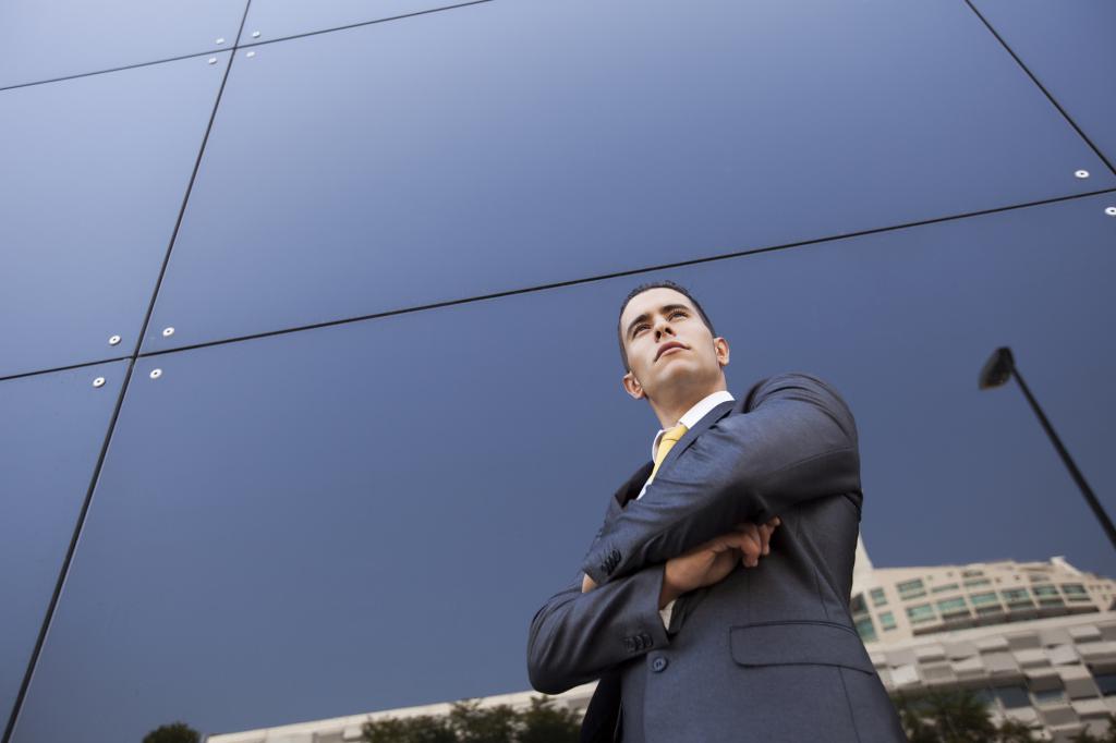 a man by the wall of a building