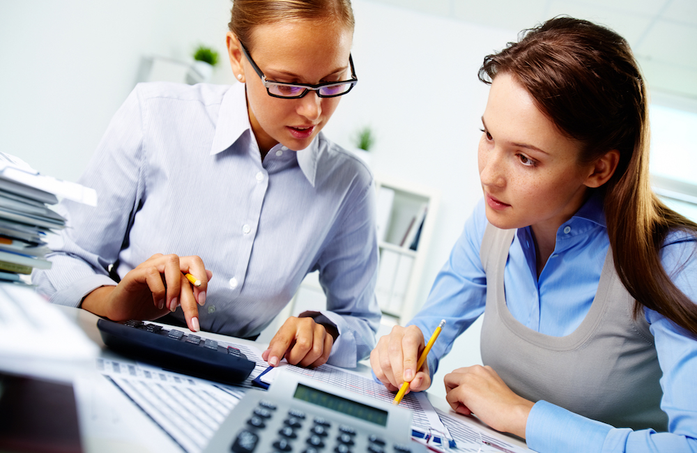 Two girls analyze information