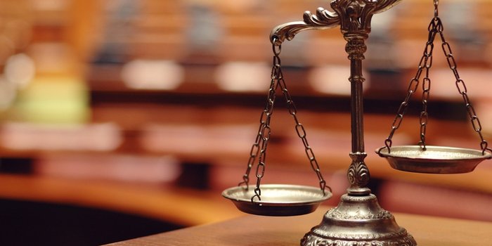 Scales on the background of the courtroom